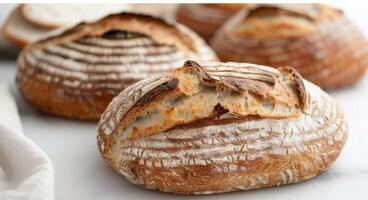 Freshly Baked Artisan Bread on a Wooden Cutting Board in a Light Kitchen photo