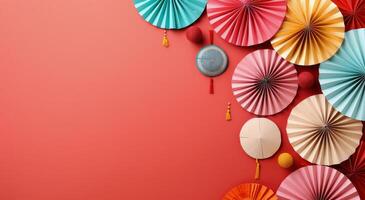 Festive Decorations With Paper Fans and Ornaments on Red Background photo