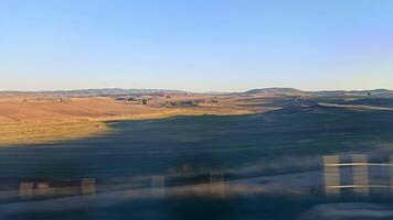 View from the train window of the high-speed train from Madrid to Valencia over the hills and countryside of Spain video