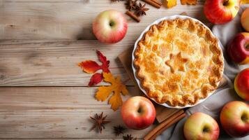 Freshly Baked Apple Pie Surrounded by Apples and Autumn Leaves on Rustic Wooden Table photo