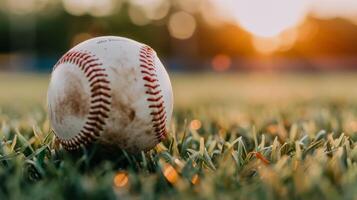 Baseball Resting on Grass With Blurred Sunset Background photo