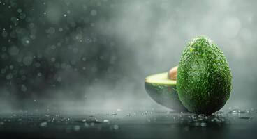 Fresh Avocados With Water Droplets on Dark Surface Under Soft Light photo