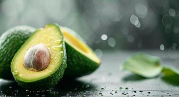 Fresh Avocados With Water Droplets on Dark Surface Under Soft Light photo
