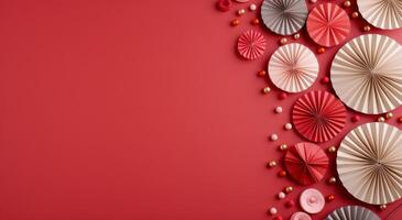 Festive Decorations With Paper Fans and Ornaments on Red Background photo