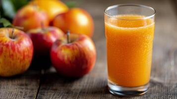Freshly Squeezed Orange Juice With Apples on Rustic Wooden Table photo