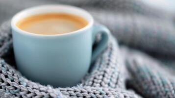 Cozy Coffee Cup Wrapped in Soft Knit Scarf on a Chilly Day photo