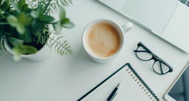 Home Office Workspace With Laptop Coffee Notepad Glasses And Smartphone photo