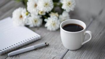 Cozy Morning Coffee With Flowers and Notebook on Wooden Table photo