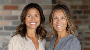 Two Women Smiling Together in Office Setting During Daylight photo