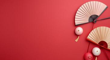 Elegant Paper Umbrellas and Chopsticks on Red Background photo