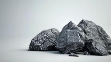 Black Rough Rocks Piled on Light Background photo