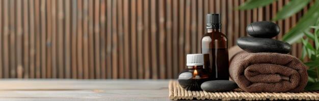 Spa Essentials With Stones, Oils, and Towels on a Wooden Table photo