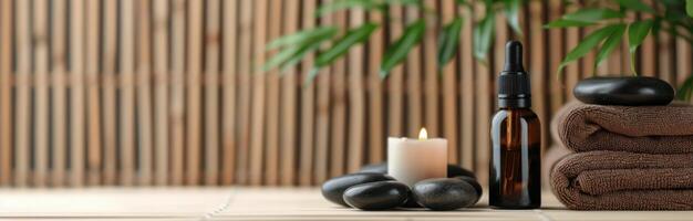 Spa Essentials With Stones, Oils, and Towels on a Wooden Table photo