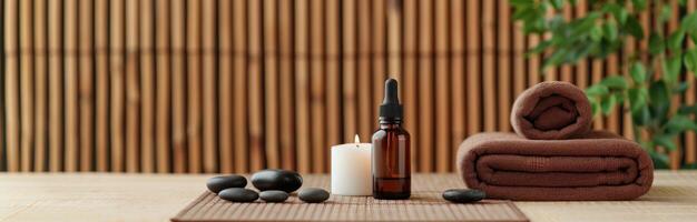 Spa Essentials With Stones, Oils, and Towels on a Wooden Table photo