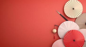 Elegant Paper Umbrellas and Chopsticks on Red Background photo