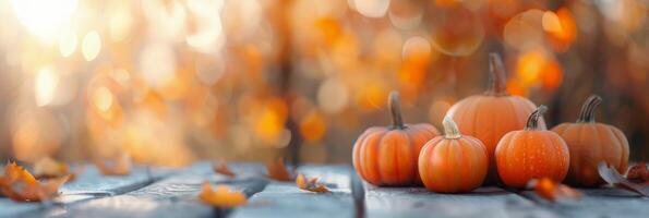 Pumpkins Gathered on Wooden Surface With Autumn Bokeh Background photo