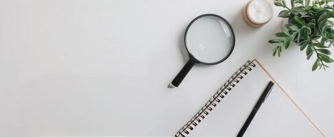 Magnifying Glass on Documents With Pink Pen in Brightly Lit Workspace photo