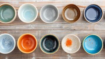 Colorful Ceramic Bowls Arranged on Weathered Wooden Surface photo