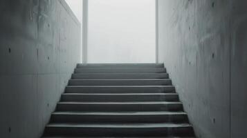 Modern Concrete Staircase With Large Window Overlooking Foggy Landscape photo