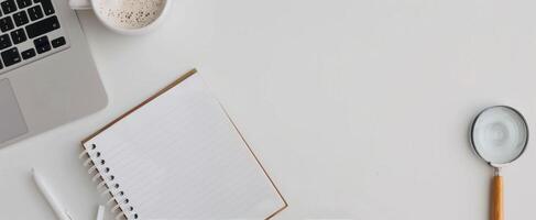 Open Notebook With Magnifying Glass, Orange Pen, Coffee, And Succulent Plant On Table photo