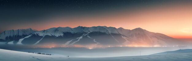 Snow-Covered Mountains at Dusk With Warm Glow in the Valley photo