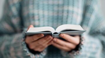 Hands on Open Book With Intricate Patterns in a Softly Lit Environment photo
