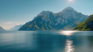 Majestic Mountain Reflected in Calm Lake Under Clear Blue Sky photo
