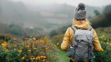 Hiker Exploring Vibrant Meadows Near a Serene Lake in Overcast Weather photo