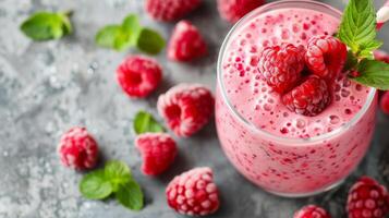 Refreshing Raspberry Smoothie With Fresh Berries on a Gray Background photo