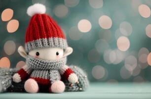 Cozy Handcrafted Knitted Snowman Toy With Red and Gray Hat on Light Green Background photo