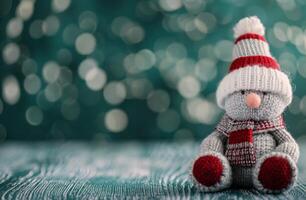 Festive Knit Snowman Ornament on Soft Green Background With Bokeh Lights photo