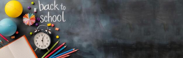 Back To School Supplies On Blackboard With Clock And Colorful Stationery photo