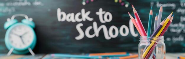Colorful Pencils in Jar With Back to School Message and Clock on Desk photo