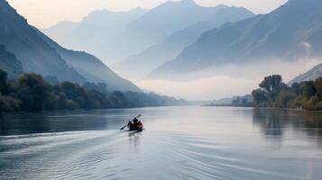 Rowboat Gliding Across Calm River at Dawn Near Misty Mountains photo