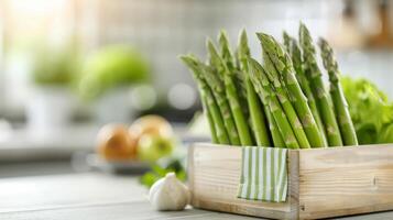 Fresh Green Asparagus Stalks in Wooden Crate on Kitchen Counter photo