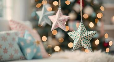 Decorative Stars Hanging on a Christmas Tree With Blurred Lights photo