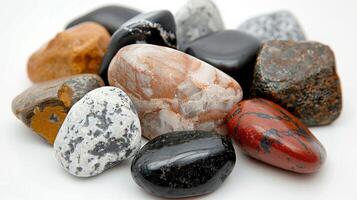 Colorful Variety of Polished Stones Displayed in a Row on a White Surface photo