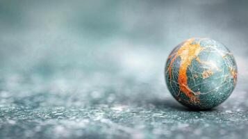 Colorful Marble Sphere on a Textured Surface in Soft Light photo