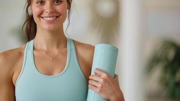 Young Woman Holding Yoga Mat in Fitness Studio During Morning Class photo
