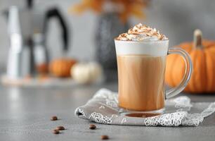 Creamy Pumpkin Spice Latte in a Cozy Setting With Seasonal Decorations photo