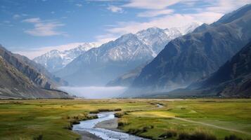 Snow-Capped Mountains Overlooking Lush Fields in Clear Sky photo