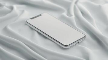 Mobile Phone Resting On Soft White Fabric In A Minimalist Setting photo