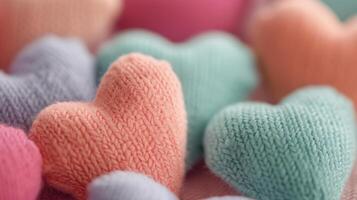 Colorful Knitted Hearts Arranged on a Cozy Textile Background photo