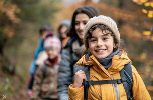 Family Enjoys Autumn Hike in Colorful Forest With Children Smiling and Laughing photo