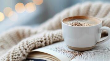 Cozy Coffee Moment With Book on a Soft Knit Blanket photo