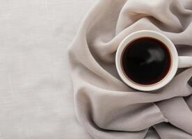 Cup of Black Coffee on Soft Cream Fabric photo