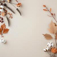 Autumn Leaves and Cotton Branches Arranged on Beige Background for Seasonal Decor photo