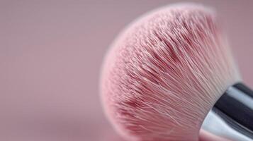 Close-Up of Pink Makeup Brush Against Soft Pink Background photo