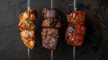 Row of Skewered Steaks on Black Surface photo