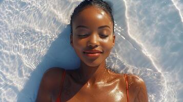 Woman in Orange Bathing Suit Relaxing on Beach photo